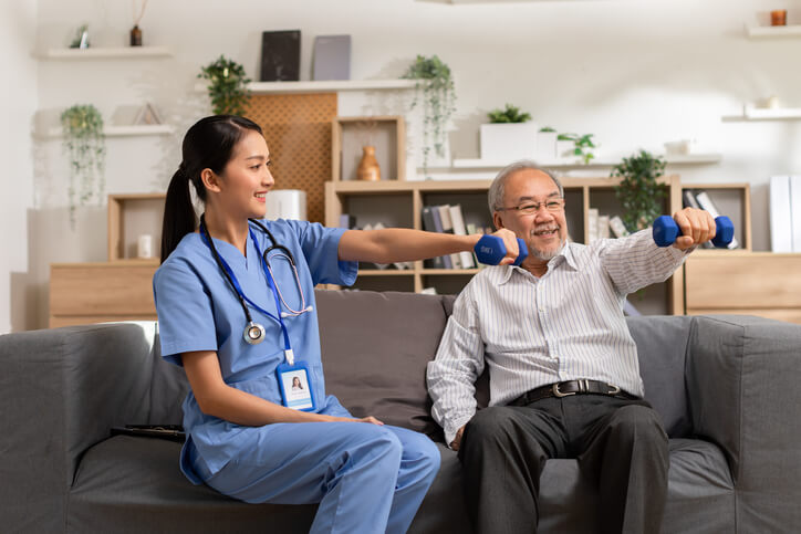 The nurse and patient are doing weightlifting exercises during skilled nursing care in Shreveport, LA.