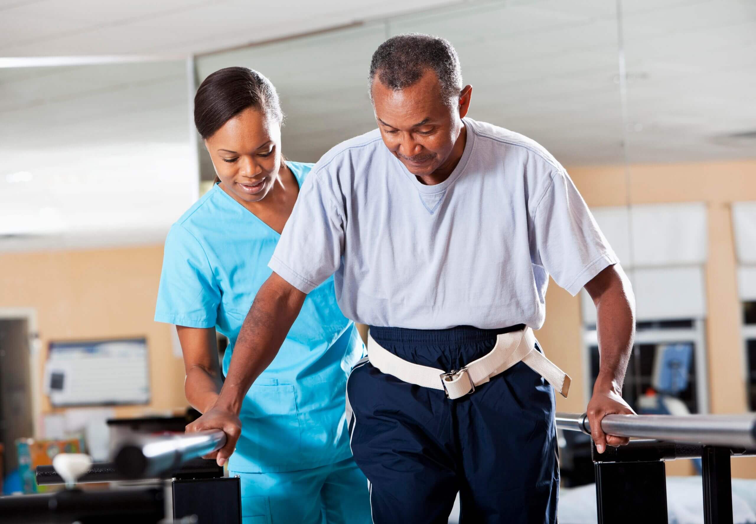 A man and woman in scrubs work out for stroke recovery rehabilitation in Shreveport, LA