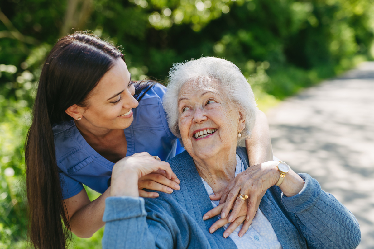 Skilled nursing nurse hugging elderly woman resident while on a walk at the nursing home in Shreveport, LA